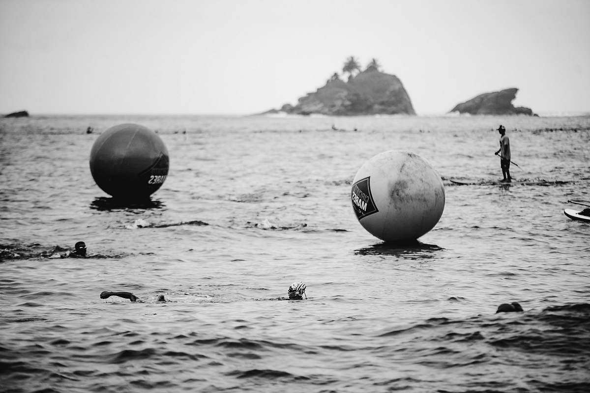 black-and-white person near two balls grey