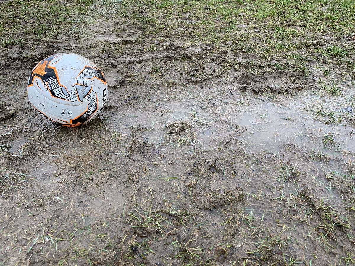 ground white and orange soccer ball on the ground ball