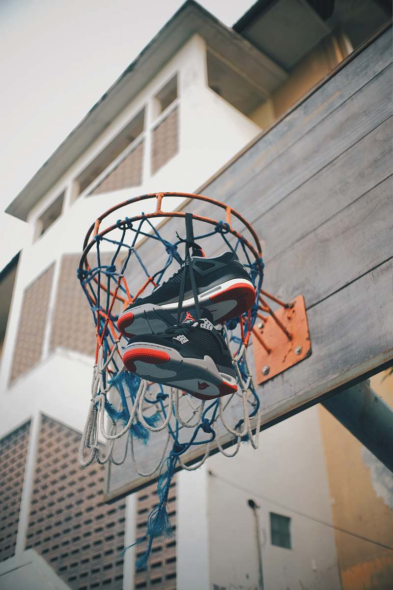 team Air Jordan shoes in basketball hoop hanging on net during daytime sports