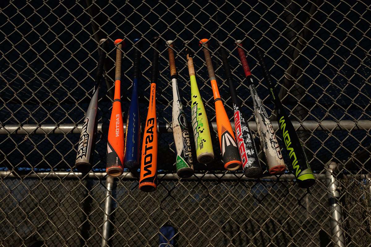 fence baseball bats hanged at the fence of the field baseball