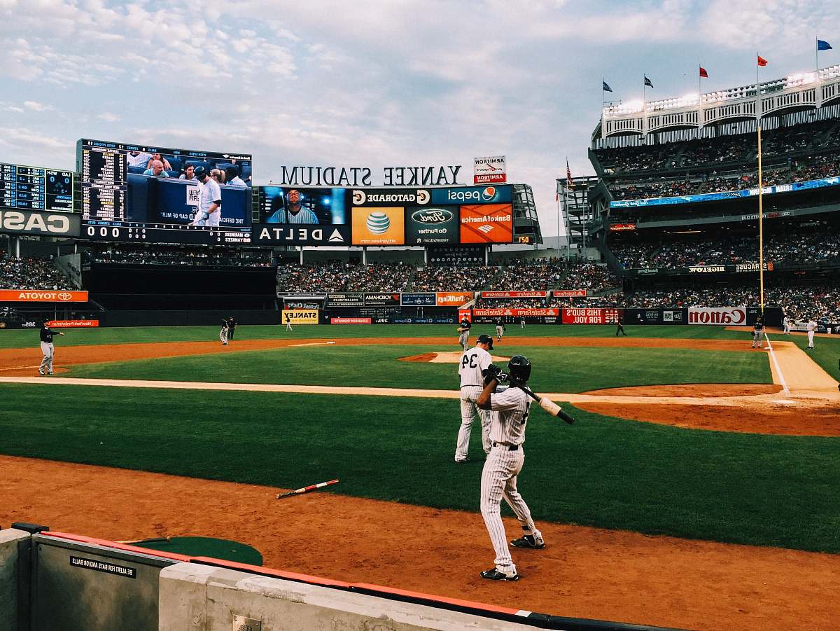 sports baseball players playing on field during daytime baseball
