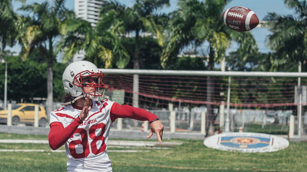 sports football player throwing footbal football