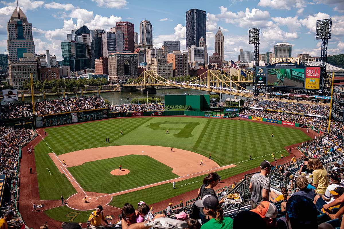 building game at baseball court surrounded by fans stadium