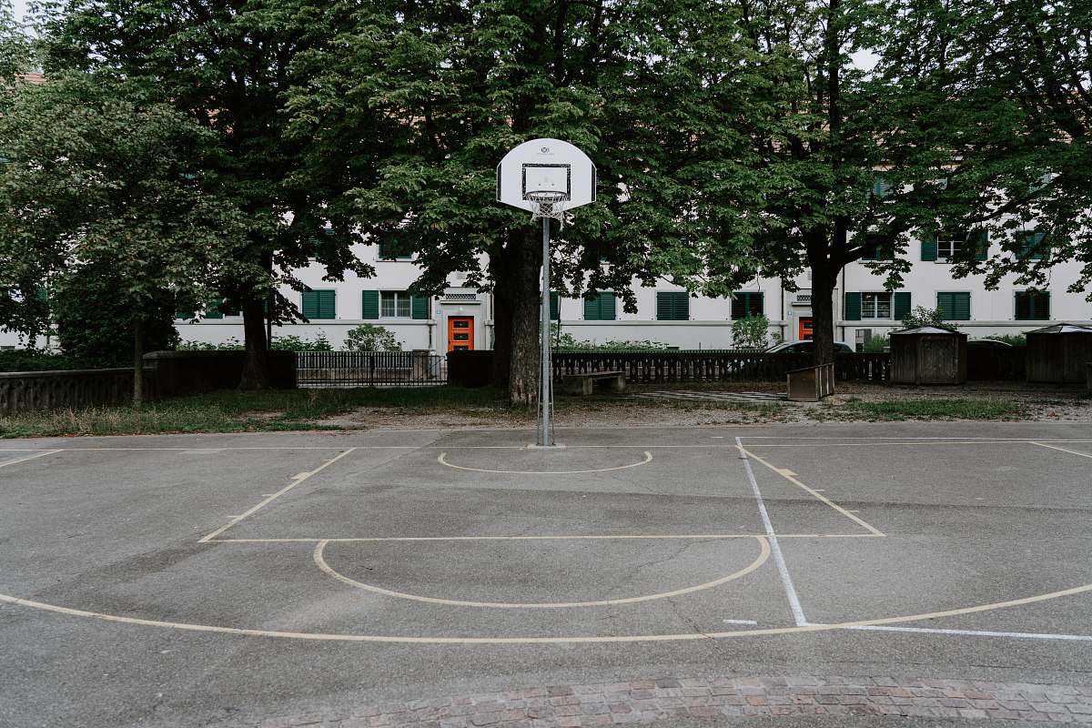 basketball white basketball hoop near trees basketball court