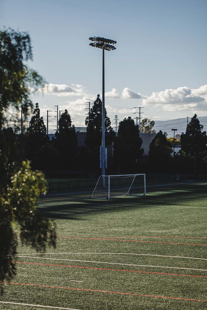 sports white soccer field post lights during daytime team
