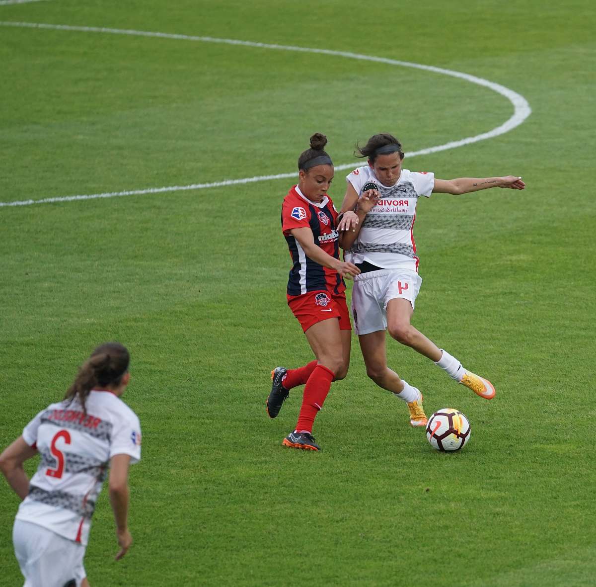 football women playing soccer on field soccer