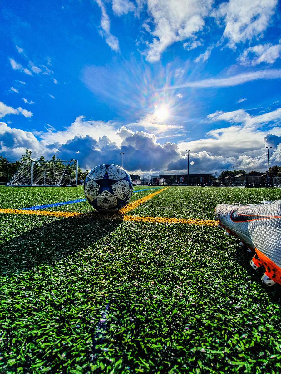 Football Blue And Grey Soccer Ball On Green Field Under White And Blue ...