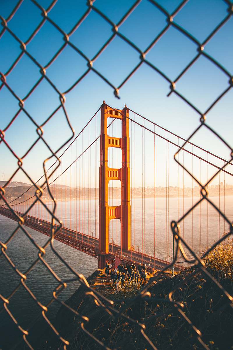 Capture the essence of urban sports in this stunning architectural photography featuring a basketball court set against the iconic Golden Gate Bridge. The juxtaposition of the dynamic game with the majestic backdrop creates a visually striking composition, perfect for sports enthusiasts, urban design projects, and promotional materials for local basketball events. This image illustrates the vibrant intersection of athleticism and architectural beauty, inviting viewers to appreciate both the sport and the landmark.