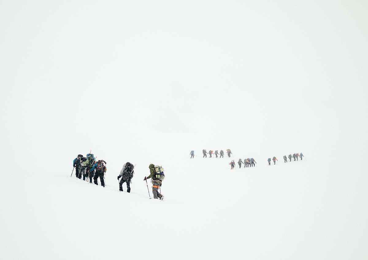 snow group of mountaineers hiking on snowy mountain people