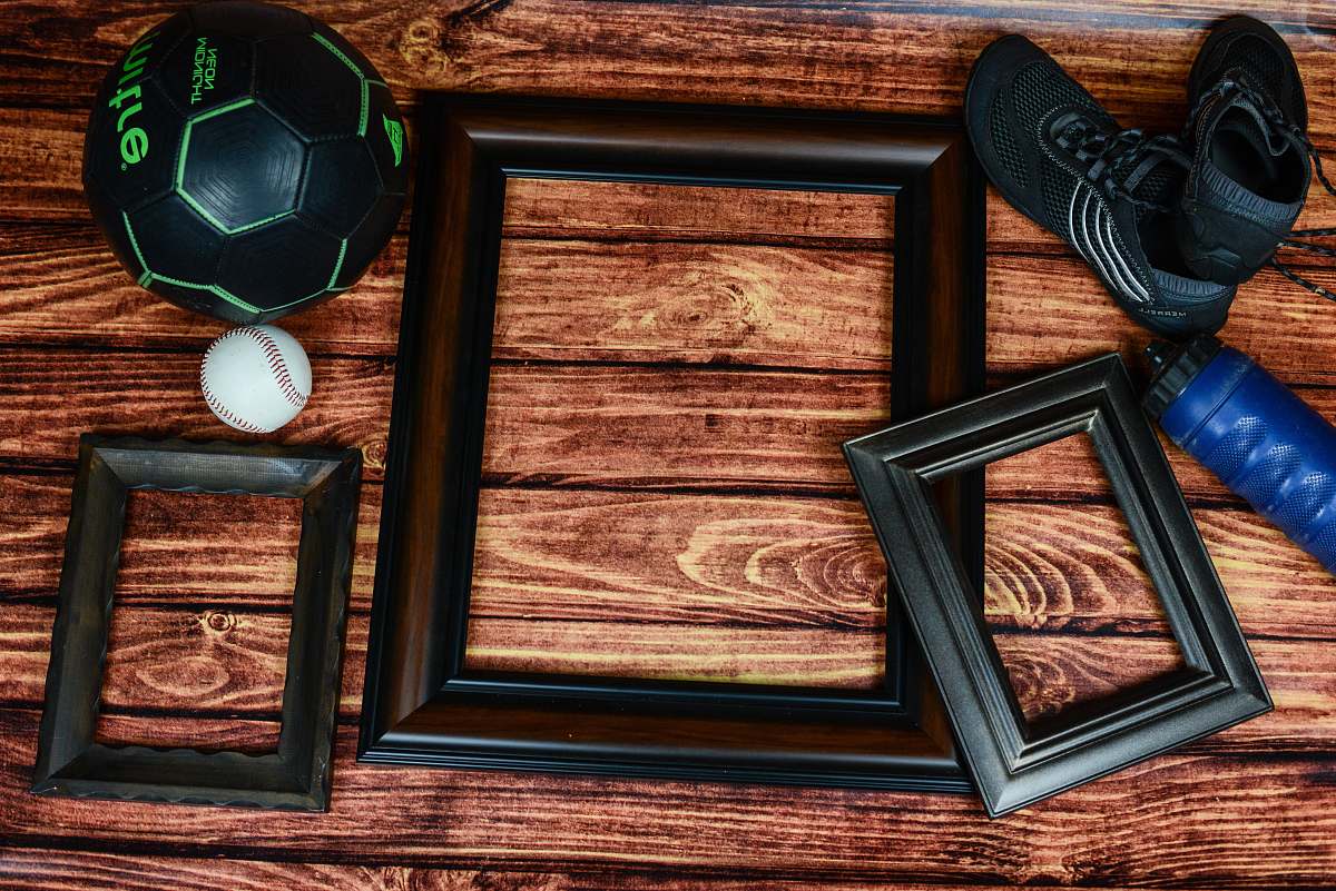 hardwood three rectangular black and brown photo frames on brown surface ball