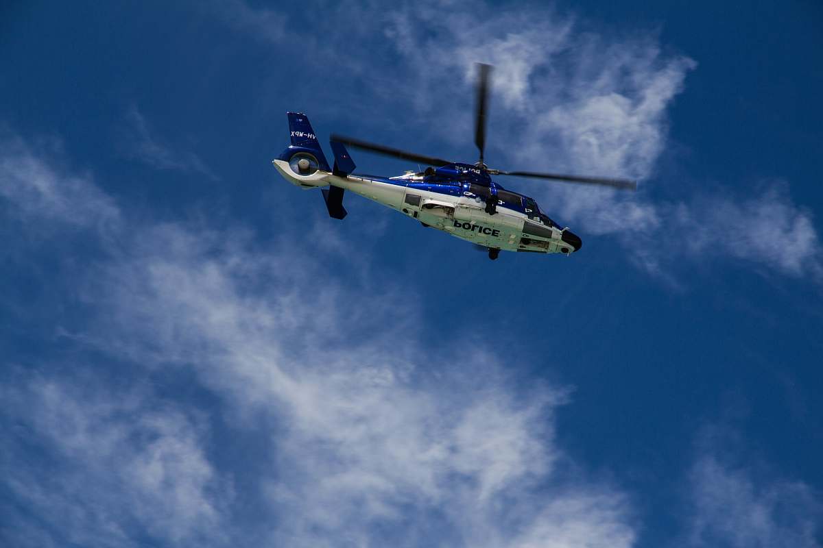 helicopter low-angle photography of white and blue helicopter transportation