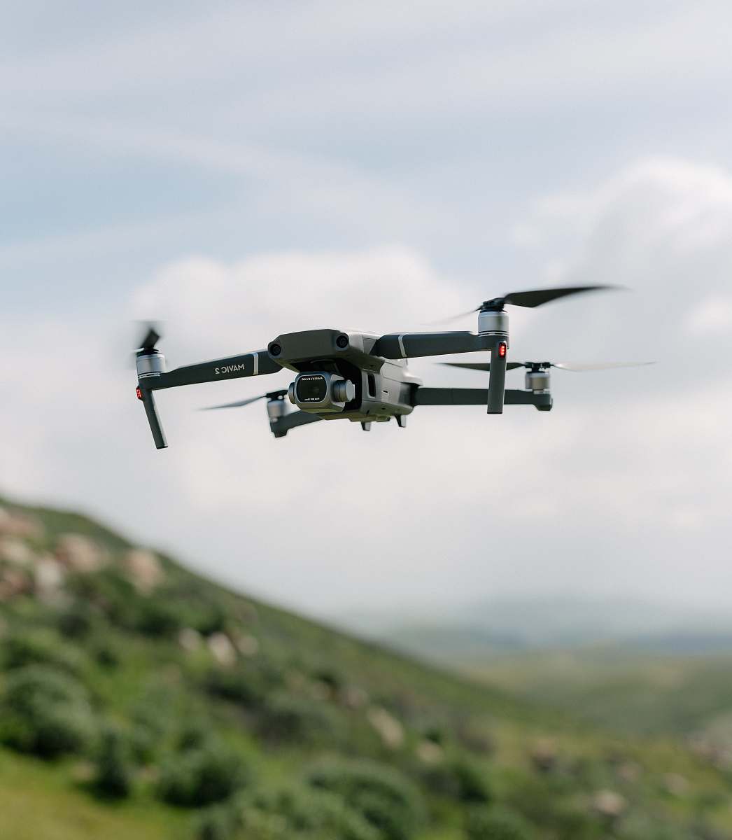 bird DJI Mavic drone flying in mid air during day flying