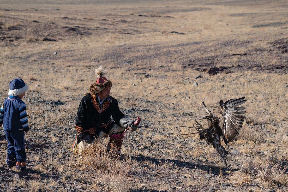 bird man and boy beside bird vulture
