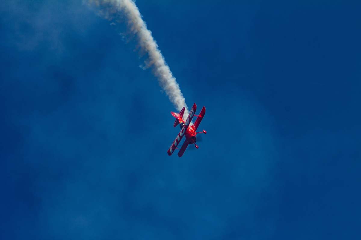 animal red bi-plane performing aerial show flying