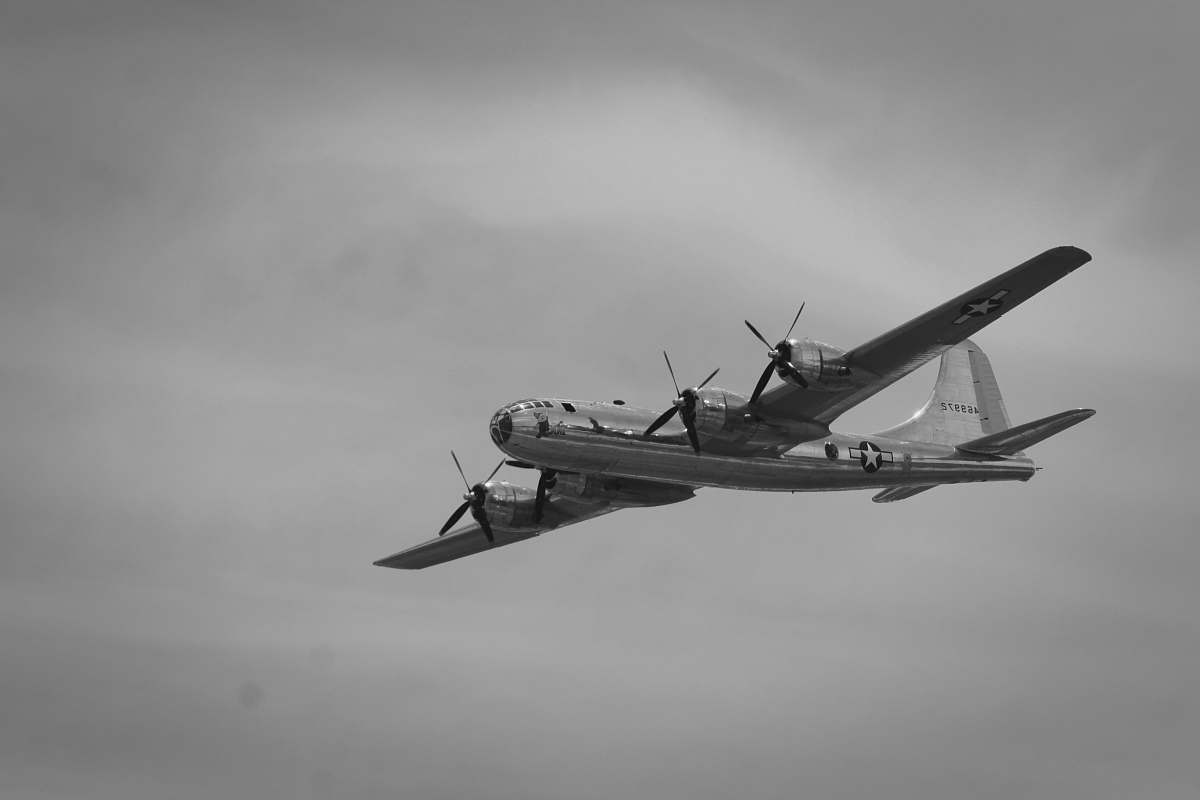 flying grayscale photography of flying plane black-and-white