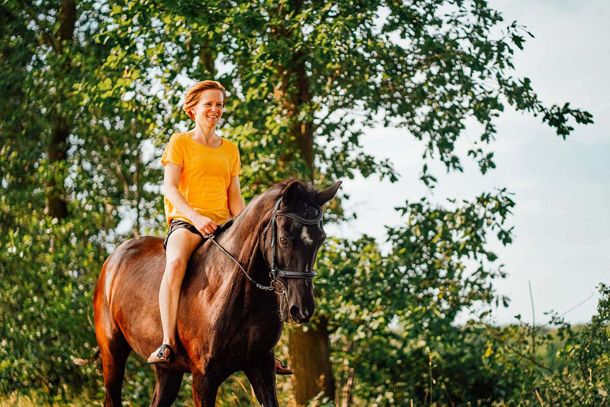mammal woman riding horse during daytime human