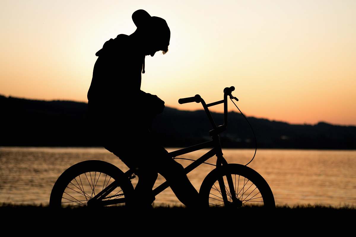 bike silhouette of man riding in bike bmx