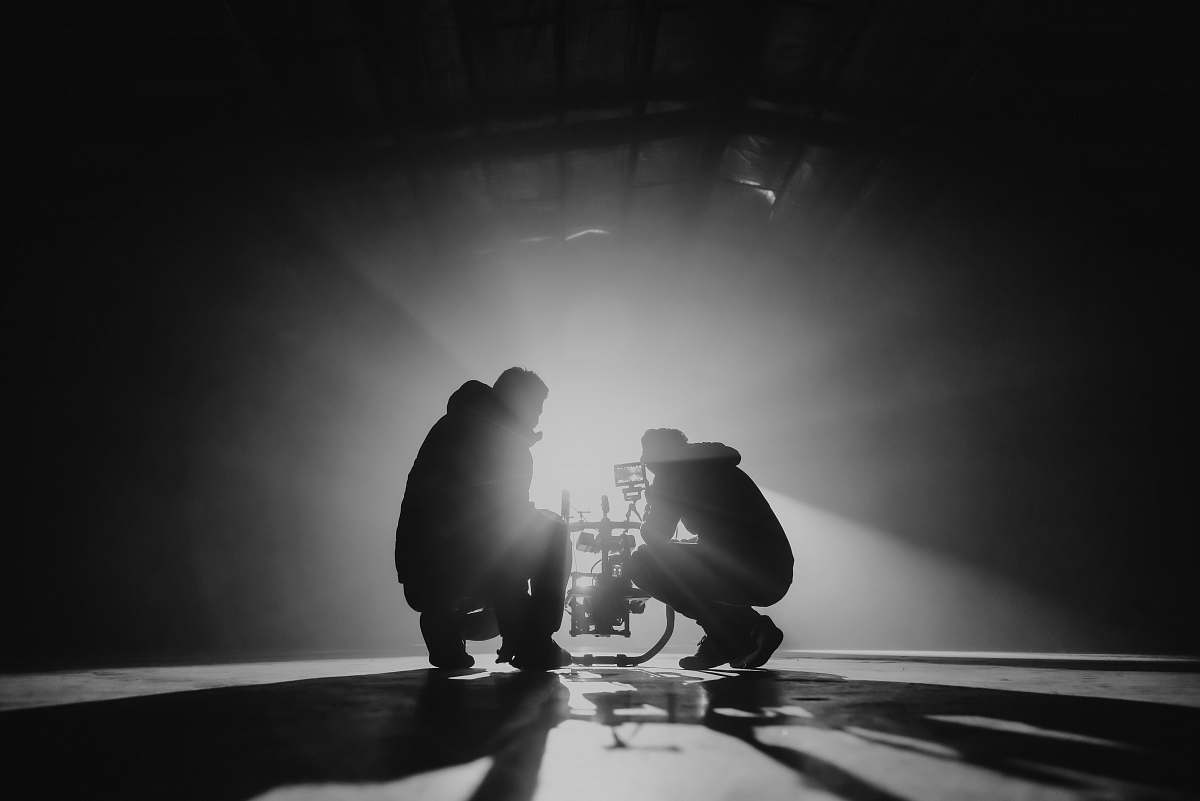 silhouette grayscale photography of two crouching men human