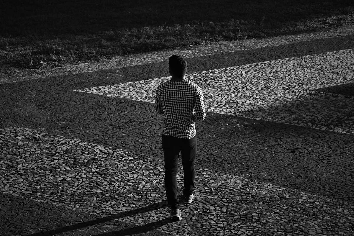 apparel man in plaid long-sleeved shirt and black pants walking clothing