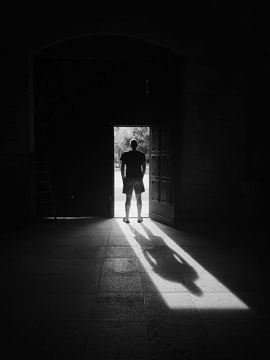 human man standing beside door person