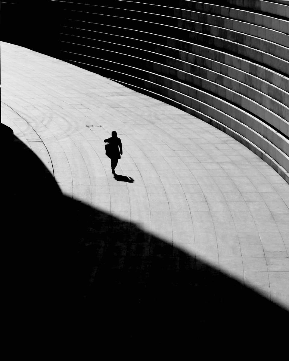 silhouette silhouette of a person walking on gray concrete floor shadow