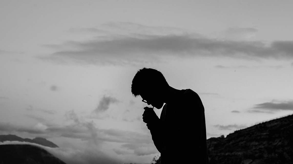 human silhouette photo of man smoking outdoors person