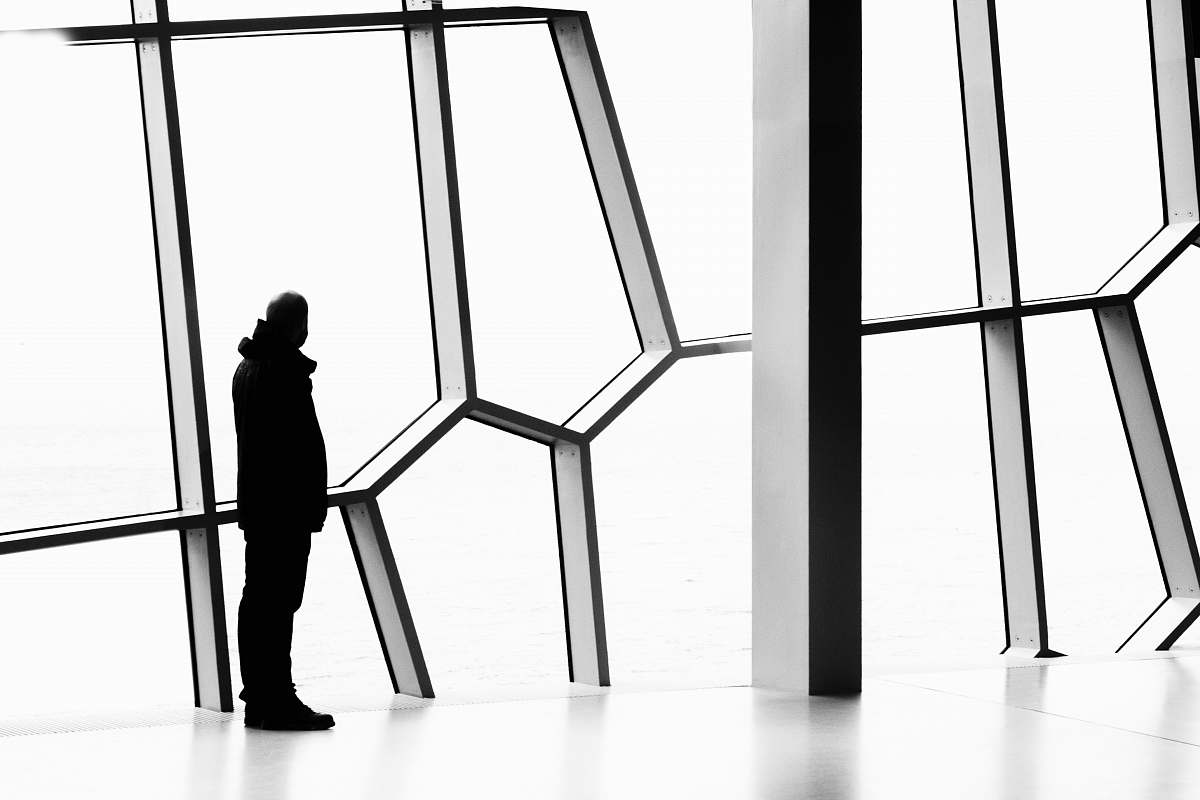 silhouette silhouette photo of person standing near window person