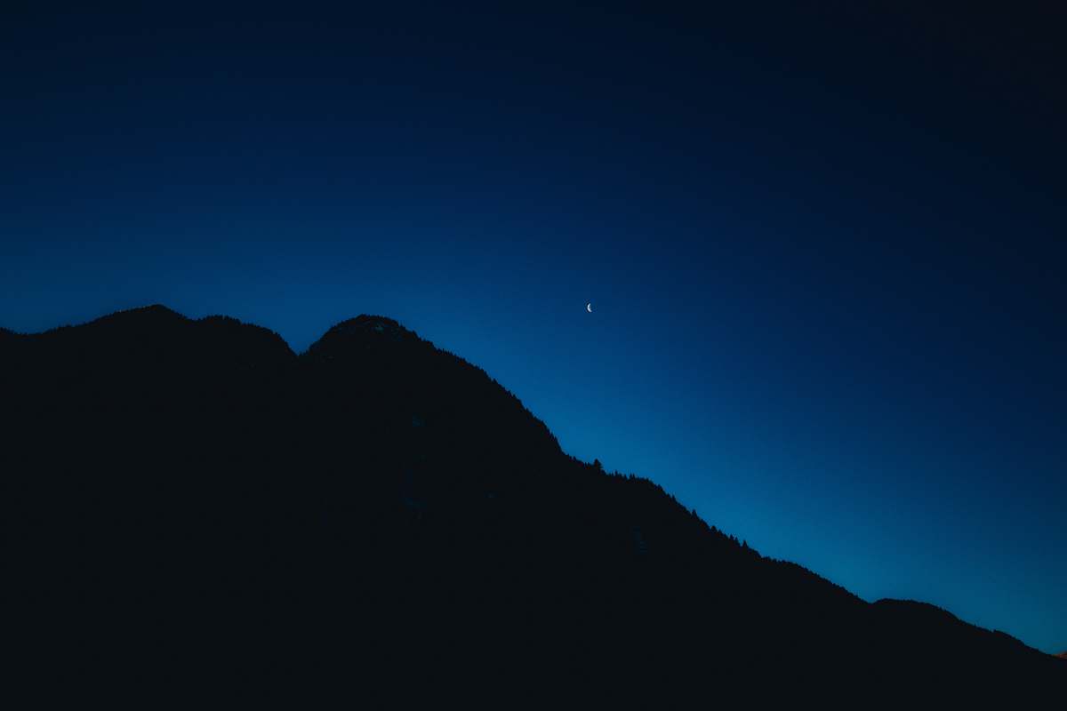 night silhouette of mountain under blue sky mountain