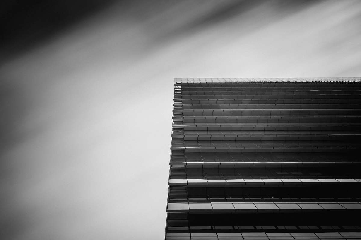 black-and-white low-angle and grayscale photography of curtain wall building office building