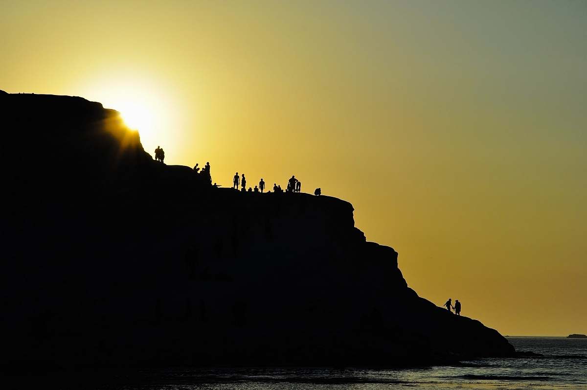 ocean silhouette of group of people on hills silhouette