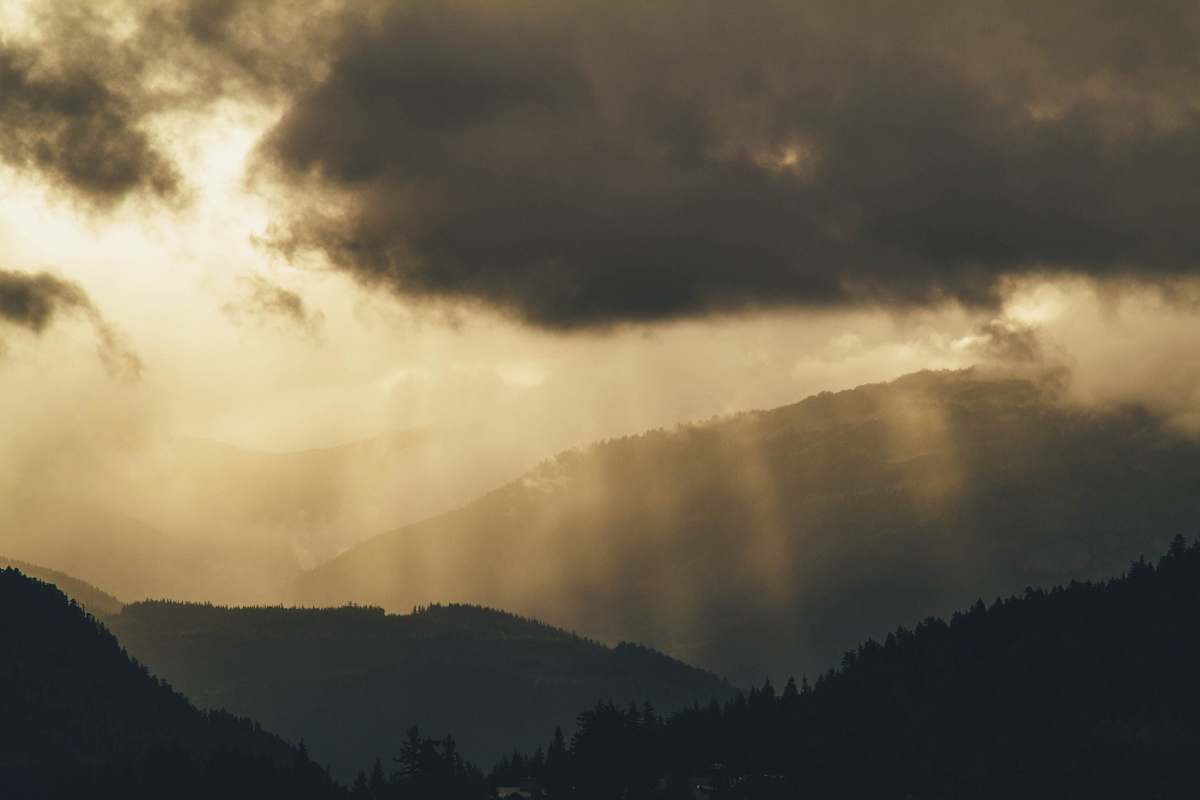 nature photo of crepuscular rays on mountains light