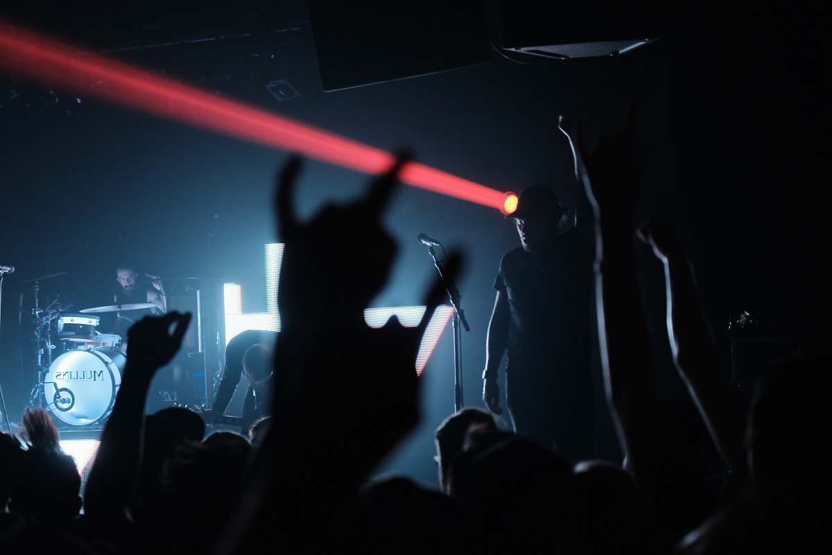 red people raising their hands on concert gig