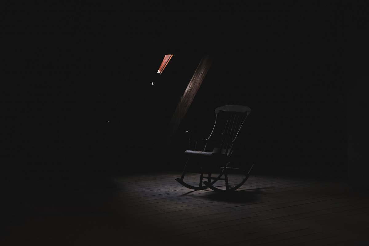 chair brown wooden rocking chair inside dark room furniture