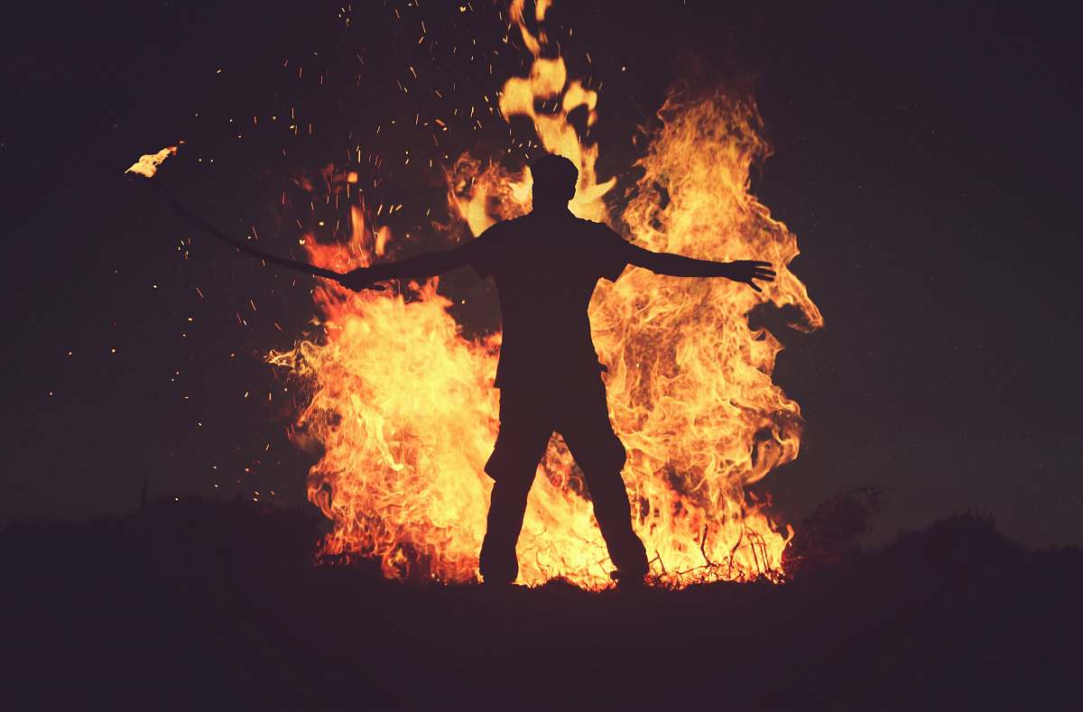 morocco person standing in front of fire during night time flame