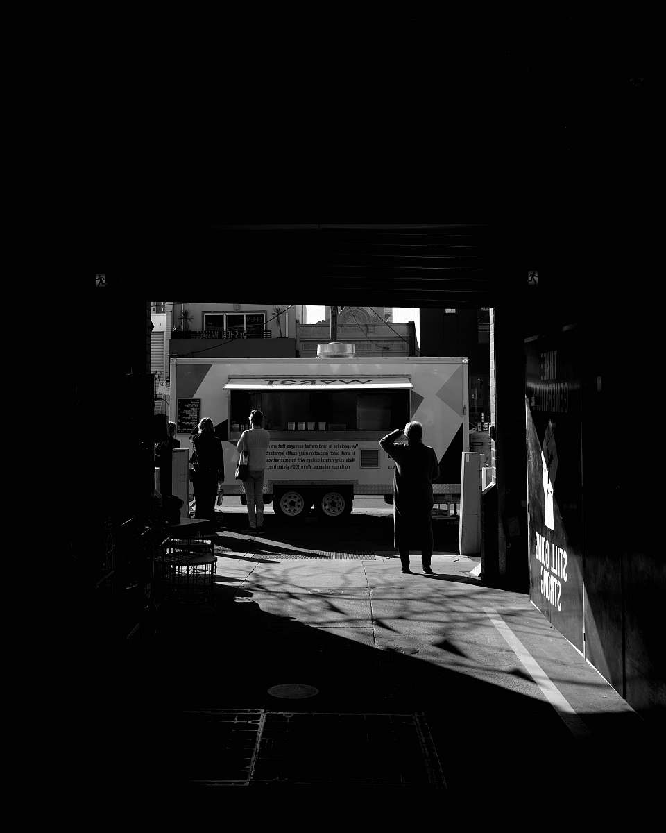 person grayscale photography of multi-stop truck black-and-white