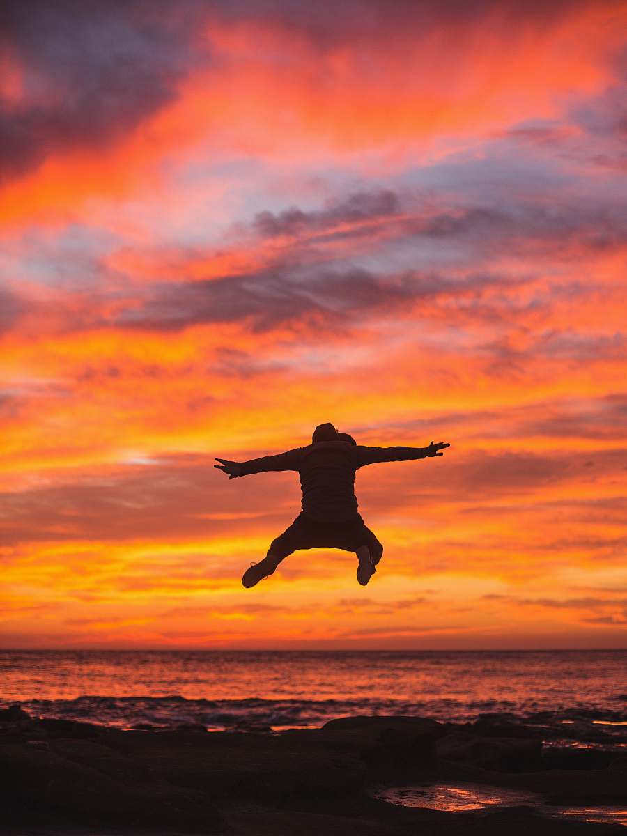 nature man jumping in seashore outdoors