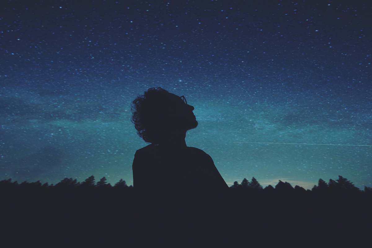 person man looking at the skies blue