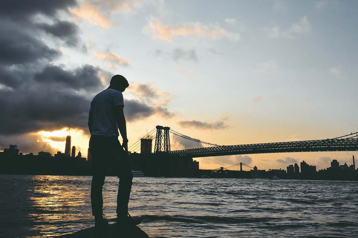 person man standing on rock standing
