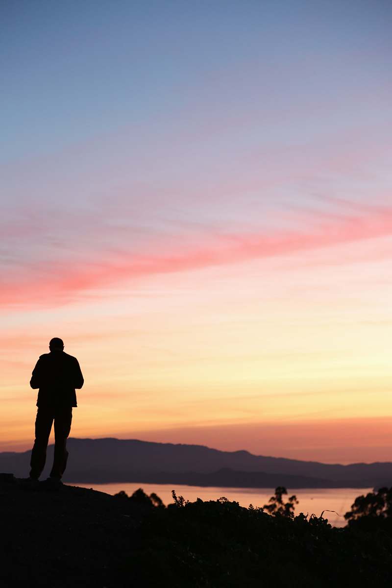 person man stands on top of the mountains standing