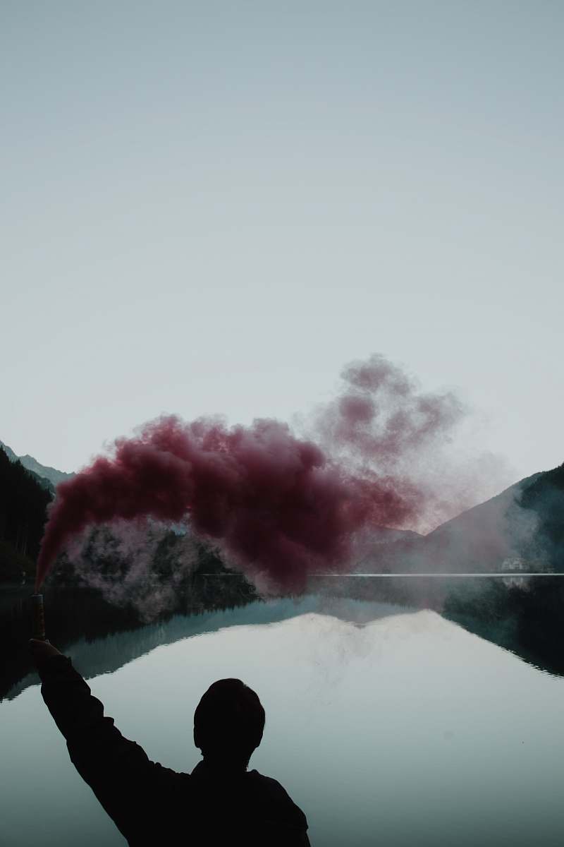people person spray red smoke person