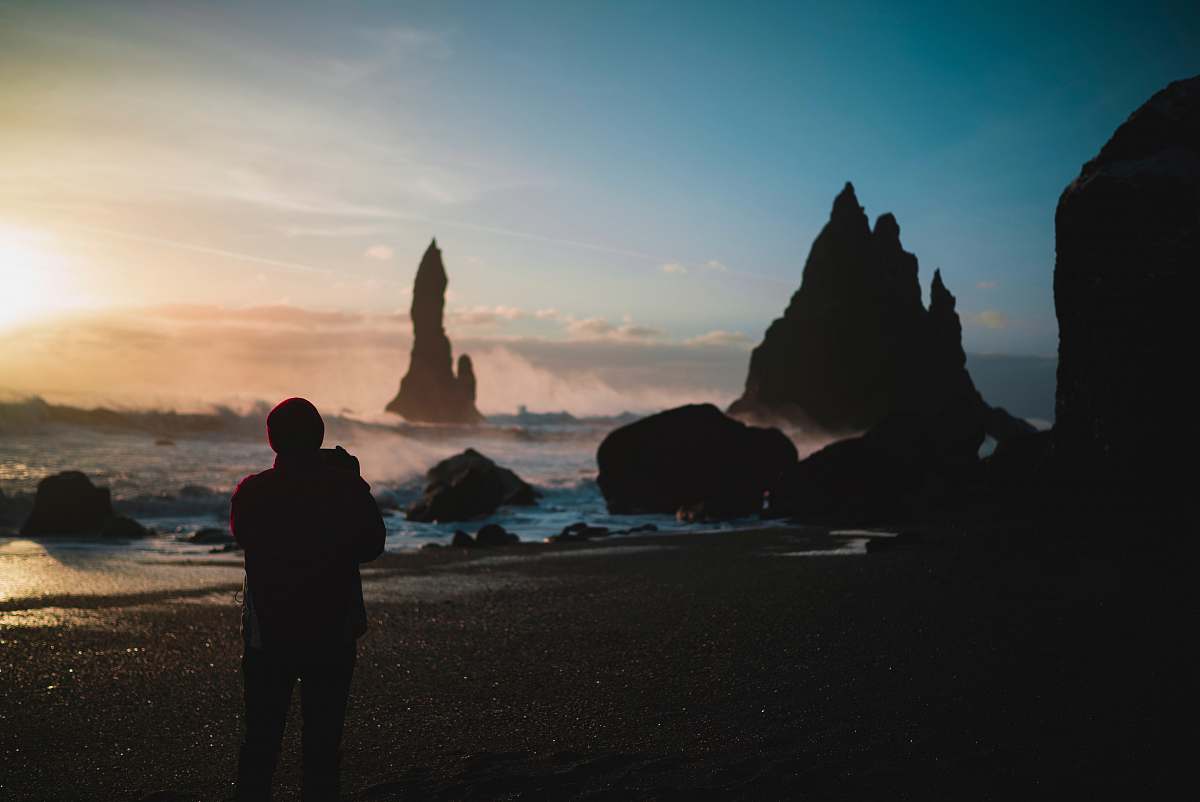 nature person standing in the beach during golden hour outdoors
