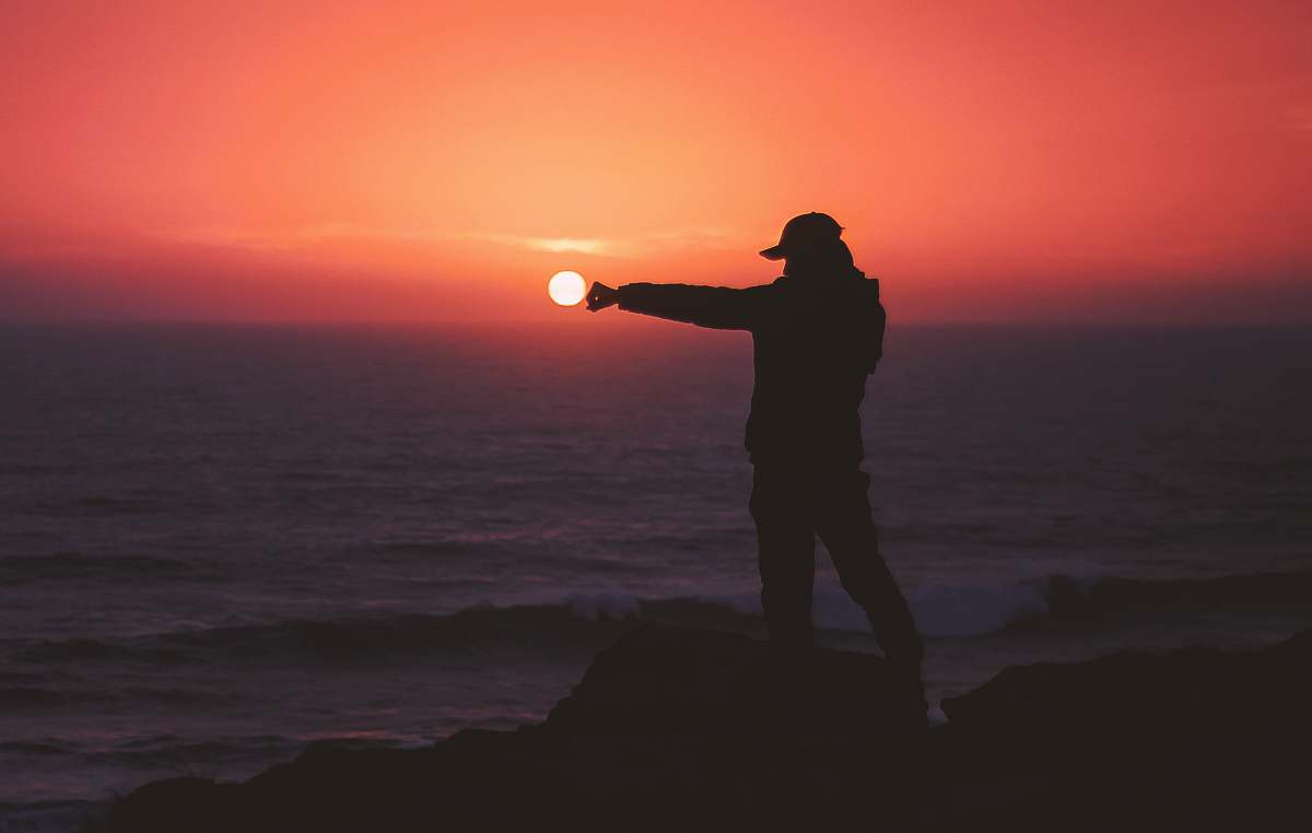person person standing on rock near body of water people