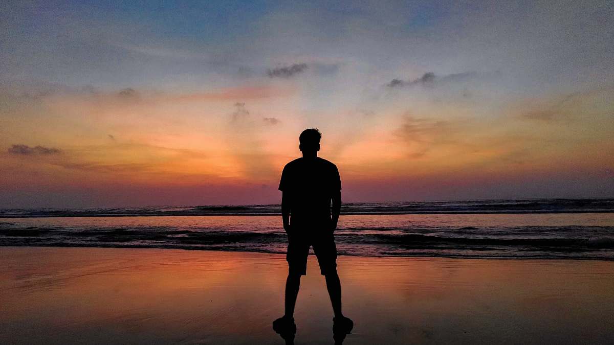 person person standing on shore during golden hour standing
