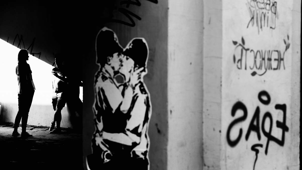 person person taking photo of white and black tunnel black-and-white