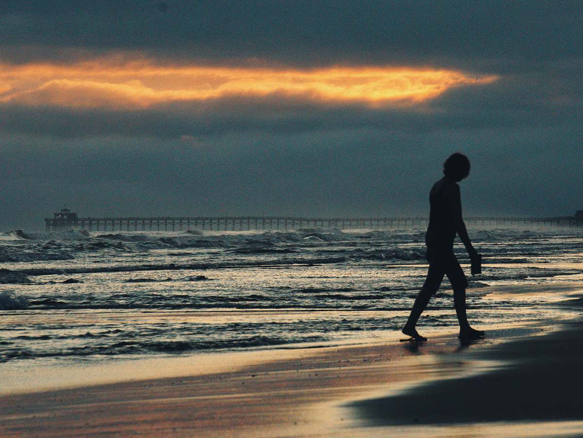 person person walking on seashore water