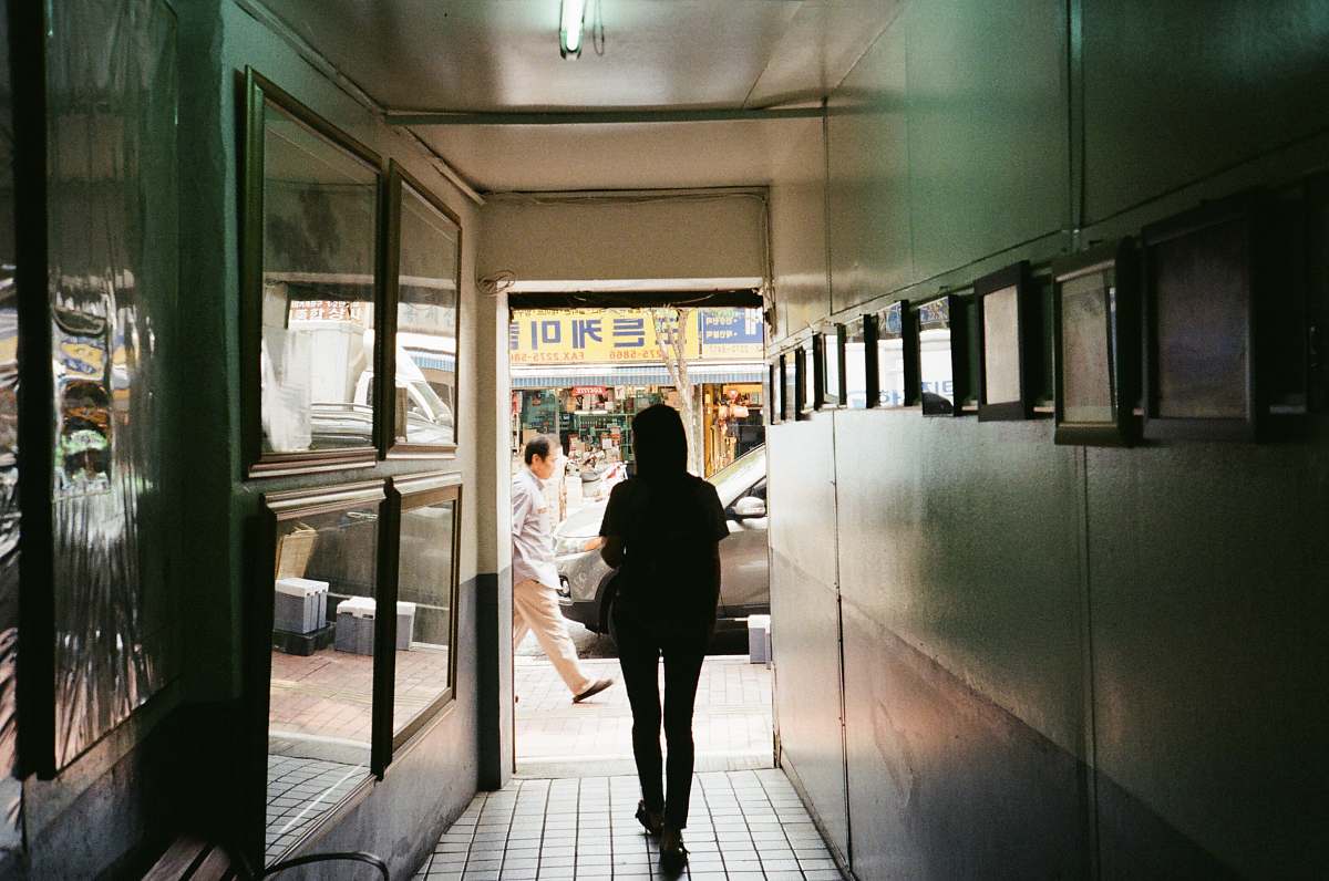 person silhouette of a woman walking at the corridor people