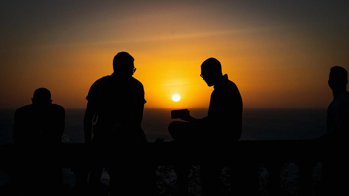 nature silhouette of four people sunlight