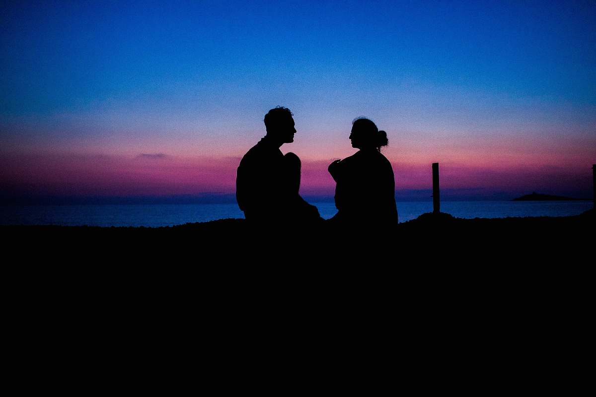 person silhouette of man and woman sitting people