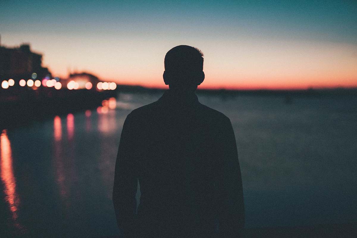person silhouette of man front of sea people