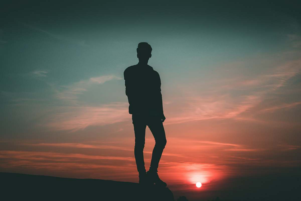 person silhouette of man standing during twilight people
